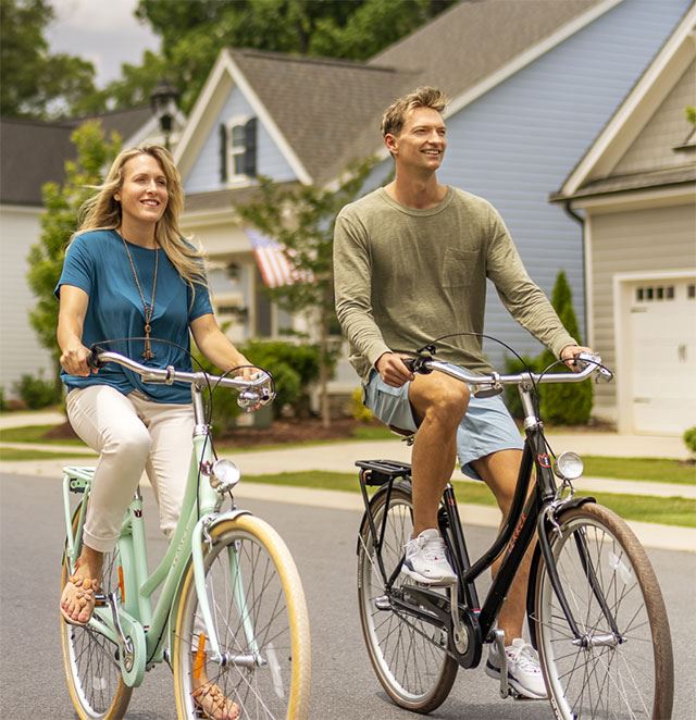 Couple riding bicycles in Wendell Falls