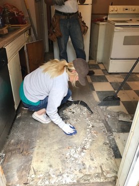 Cali helping replace flooring in the kitchen