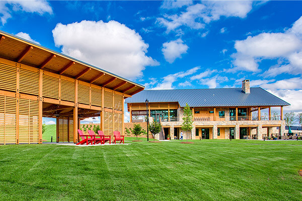 Farmhouse cafe and wooden shelter in open space in Wendell Falls