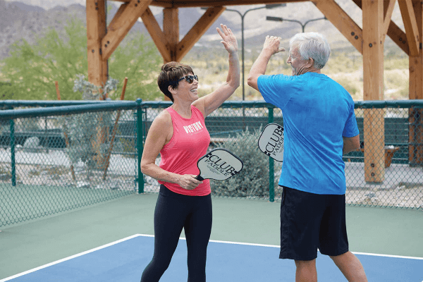Couple enjoying a game of pickle ball