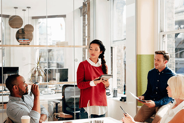 Group of colleagues meeting in a bright conference room
