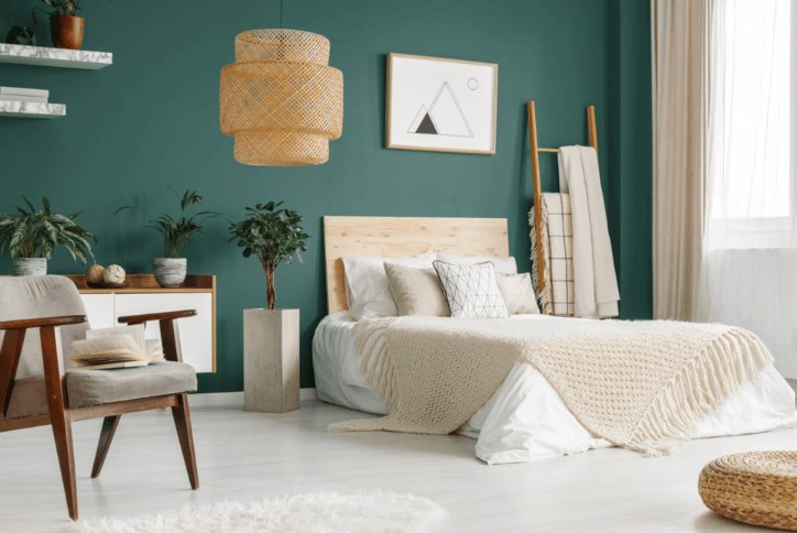 Bedroom staged with dark walls and simple modern furnishings