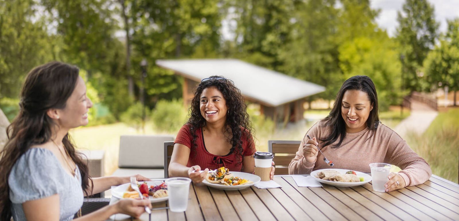 Women dining on outdoor patio in Wendell Falls