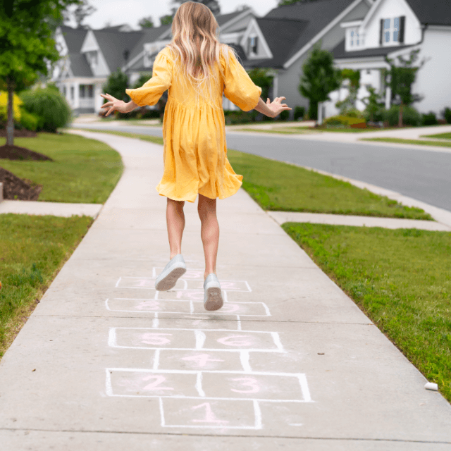 Girl playing hopscotch in Wendell Falls